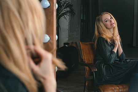 woman sitting on chair front of mirror thumbnail