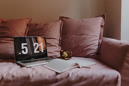Workplace with a laptop on a pink couch thumbnail
