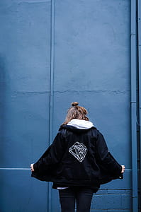 person looking down wearing black jacket thumbnail
