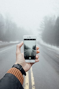 person taking photo of foggy road thumbnail