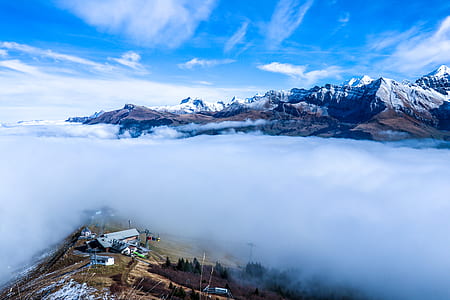 landscape photography of snowy mountains covered with fog thumbnail