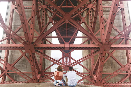 two person on red metal building framework thumbnail