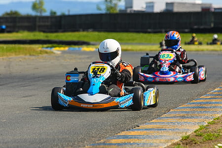 two person driving go kart on track at daytime thumbnail