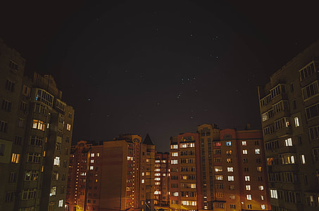 brown and grey painted high-rise building photography during night time thumbnail
