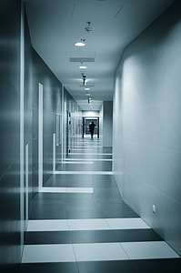 close photo of person walking in pathway on building thumbnail