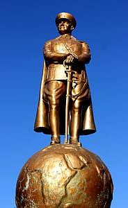 man statue wearing army suit holding cane under blue sky at daytime thumbnail