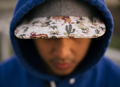 shallow focus photography of hooded man thumbnail