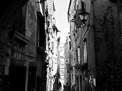 grayscale photography of alley between concrete buildings thumbnail