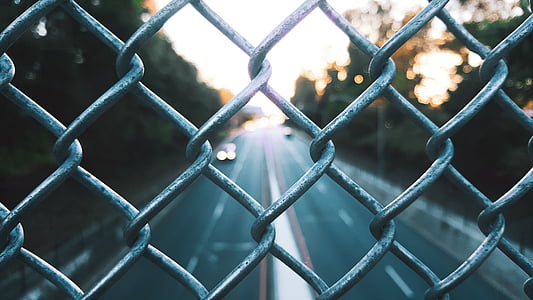 closeup photography of grey stainless steel wire fence thumbnail
