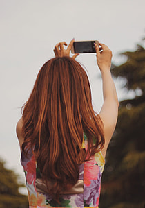 selective photography of woman taking selfie thumbnail