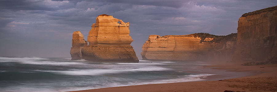 photo of large rock on body of water thumbnail