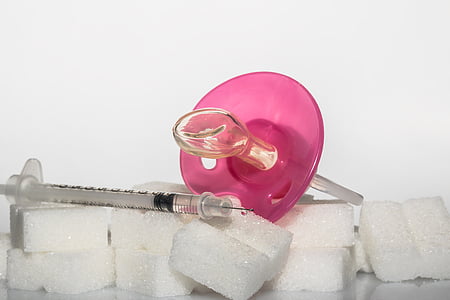 syringe on top of white foams thumbnail