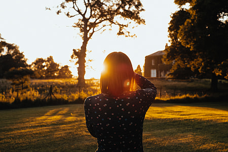 woman standing wearing black sweater during sunrise thumbnail