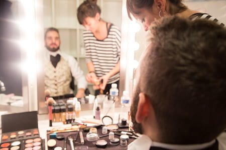 man in front of mirror sitting beside the woman thumbnail