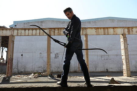 man holding black bow thumbnail