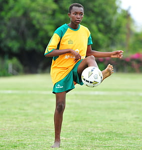 man playing soccer during daytime thumbnail