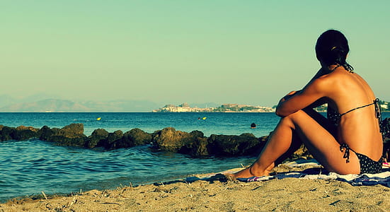 woman wearing black bikini near sea during daytime thumbnail