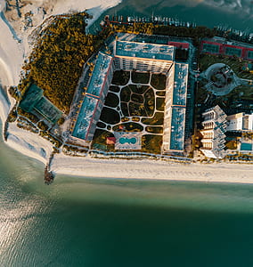 aerial view of buildings near ocean thumbnail