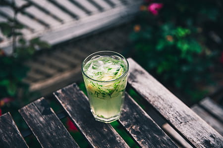 Cucumber water served in a glass on a wooden bench thumbnail