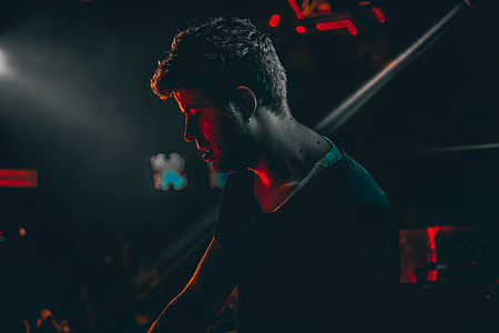 man wearing black top looking down thumbnail