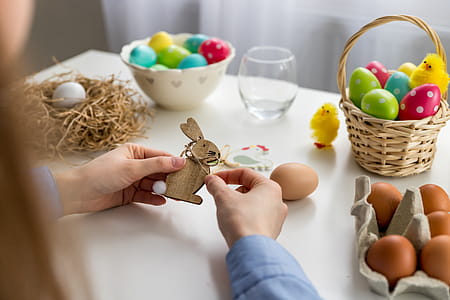 Female hands made some wooden easter ornaments. Happy Easter! thumbnail