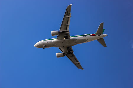gray and white airplane under blue sky at daytime thumbnail