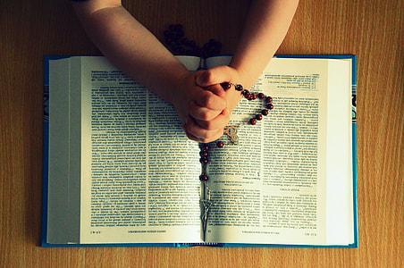 person holding rosary thumbnail
