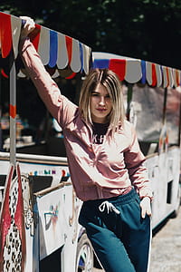 Woman Standing Beside White Kiosk thumbnail