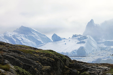 brown mountain near snow covered mountain at daytime thumbnail