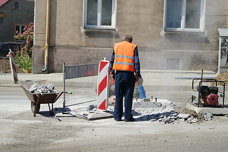 man standing in front of broken asphalt road thumbnail