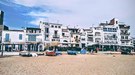 White Concrete Building Near Boat thumbnail
