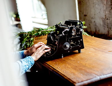 man using black typewriter on desk thumbnail