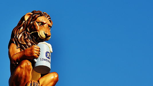 brown lion holding up mug statue thumbnail