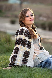 selective focus photo of woman sitting on green grass thumbnail