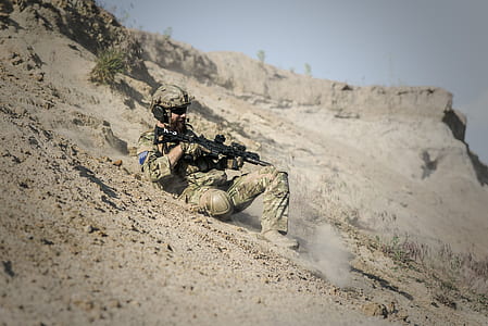 Soldier Man With Black Rifle Sliding on Cliff thumbnail