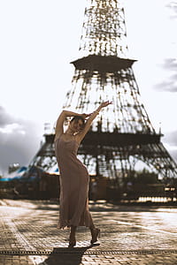 Photography Of Woman Near Tower thumbnail