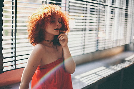 woman standing near glass window thumbnail