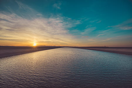 body of water under blue sky thumbnail