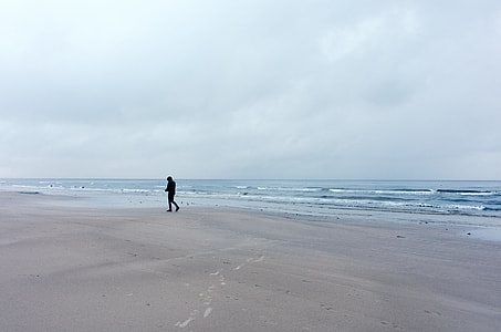 Lonely walker on the beach thumbnail
