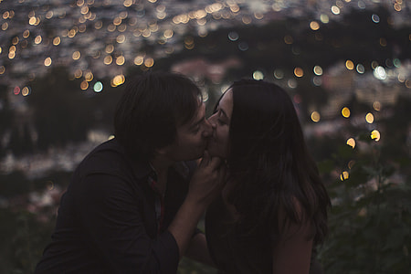 man and woman kissing bokeh photography thumbnail
