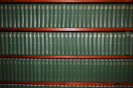 green books on wooden shelf thumbnail