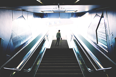 man standing in stairs inside building thumbnail