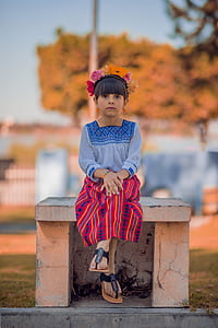 girl sitting on grey concrete bench thumbnail