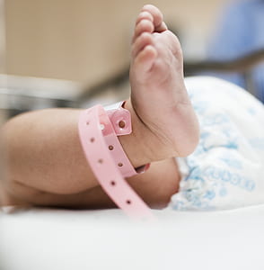 baby wearing diaper lying on white mat thumbnail