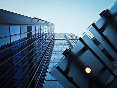 low angle photography of curtain wall high rise building under blue sky thumbnail