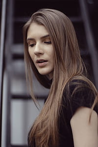shallow focus photography of woman looking down thumbnail