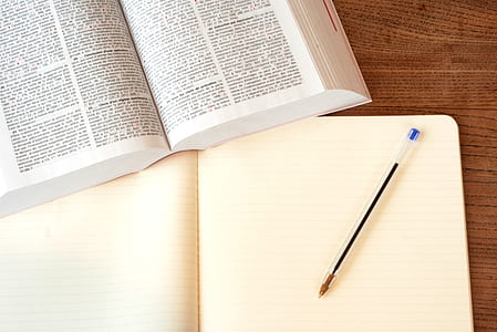 white book beside blue ballpoint pen thumbnail