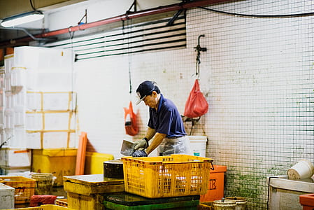 man near yellow crate inside room thumbnail