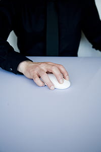 photo of person holding Apple Mighty Mouse thumbnail