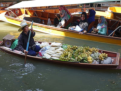 person sitting on jon boat filled with bananas thumbnail